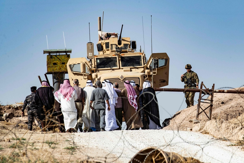 Syrian Kurds take part in a demonstration against Turkish threats at a US-led international coalition base on the outskirts of Ras al-Ain town in Syria's Hasakeh province near the Turkish border on October 6, AFP / Delil SOULEIMAN