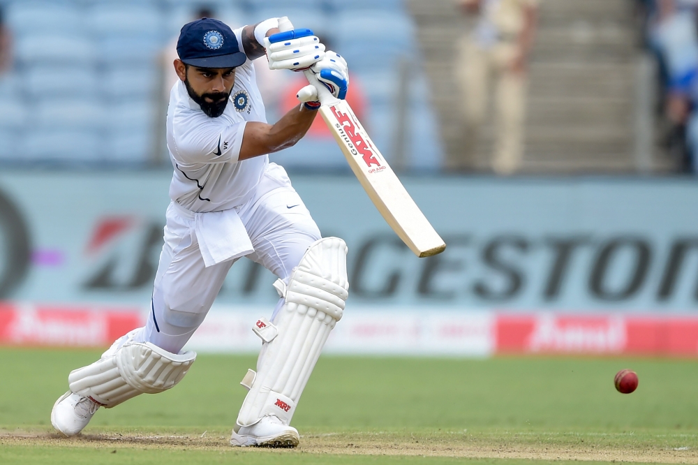 India's captain Virat Kohli plays a shot on the second day of the second Test cricket match between India and South Africa at the Maharashtra Cricket Association Stadium in Pune on October 11, 2019. (AFP / PUNIT PARANJPE)