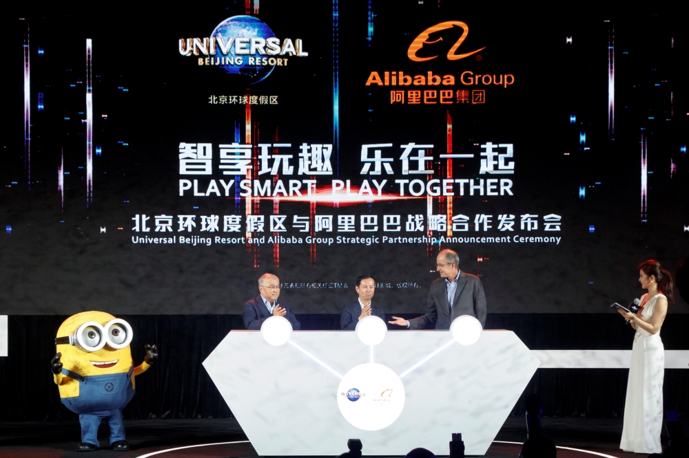 Chairman of Beijing Tourism Group Duan Qiang, Alibaba Group CEO Daniel Zhang and Comcast Corporation CEO Brian Roberts (L-R) attend a ceremony marking the announcement of a partnership between Universal Beijing Resort and Alibaba Group to create a theme p