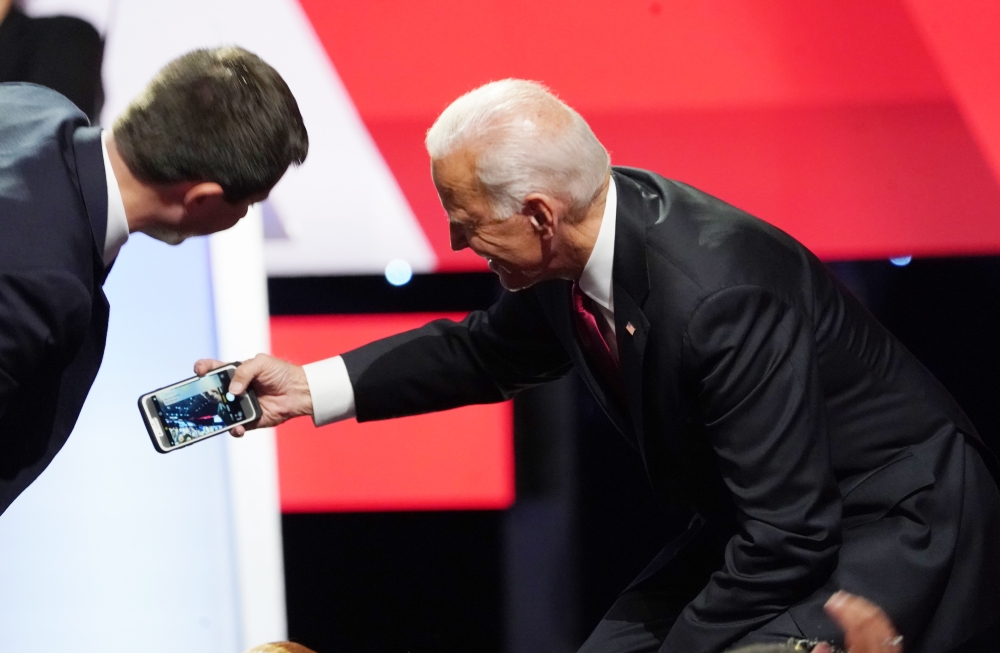 South Bend Mayor Pete Buttigieg leans in to a selfie taken by former Vice President Joe Biden with the crowd at the end of the fourth U.S. Democratic presidential candidates 2020 election debate at Otterbein University in Westerville, Ohio, October 15, 20