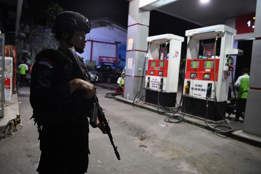 Police Mobile Brigade  stands guard at a gas station in Jayapura, Papua, August 31, 2019. (Zabur Karuru / Antara Foto via Reuters) 