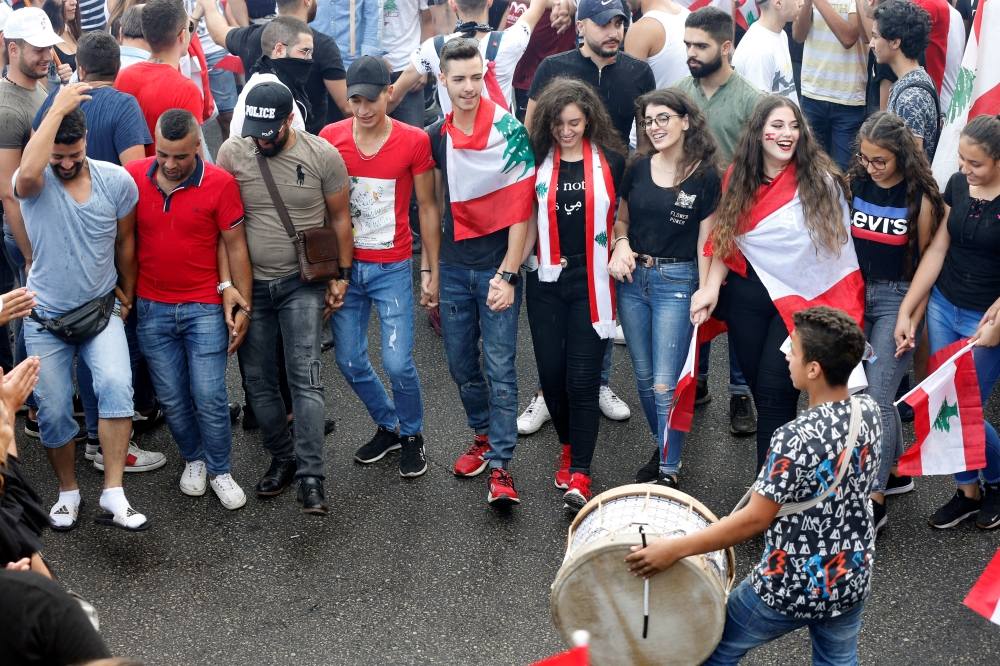 Demonstrators dance during an anti-government protest in downtown Beirut, Lebanon October 20, 2019. REUTERS/Mohamed Azakir