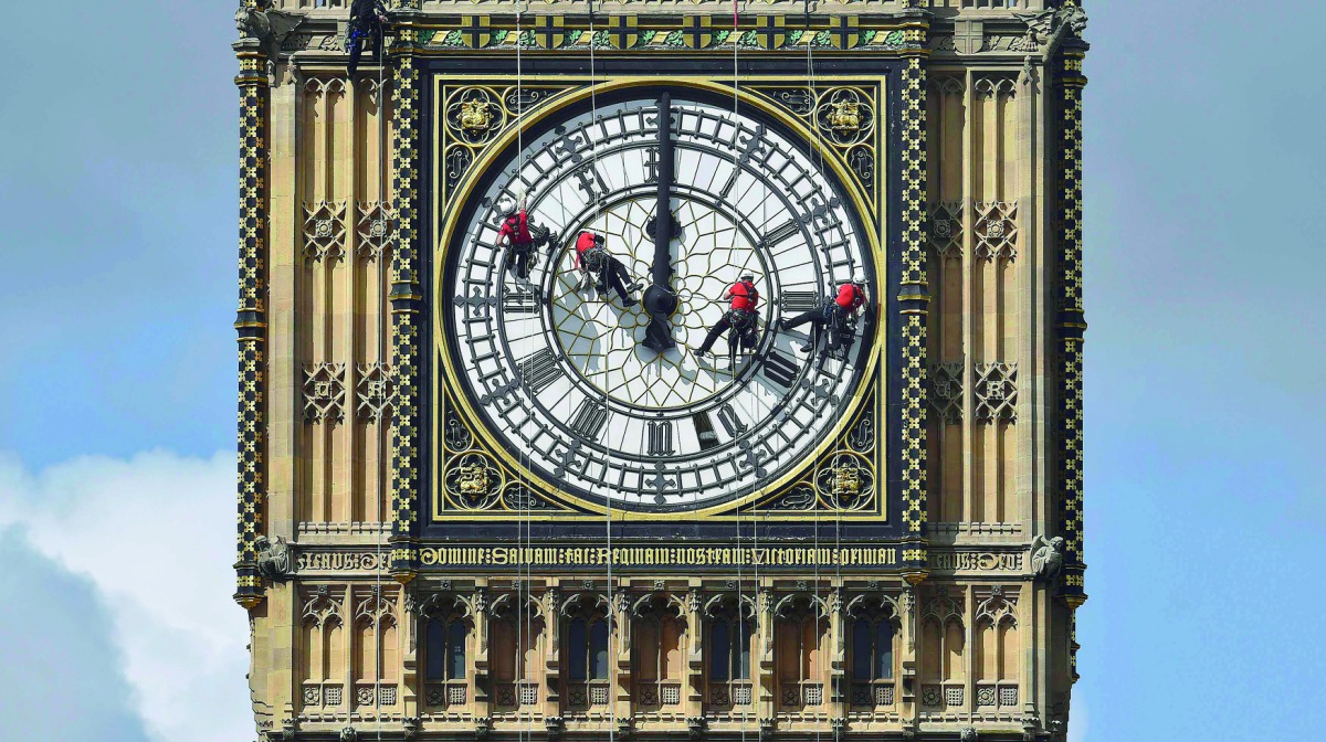 Cleaners abseil down one of the faces of Big Ben to clean and polish the clock face above the Houses of Parliament in central London, August 19, 2014. Reuters / Toby Melville