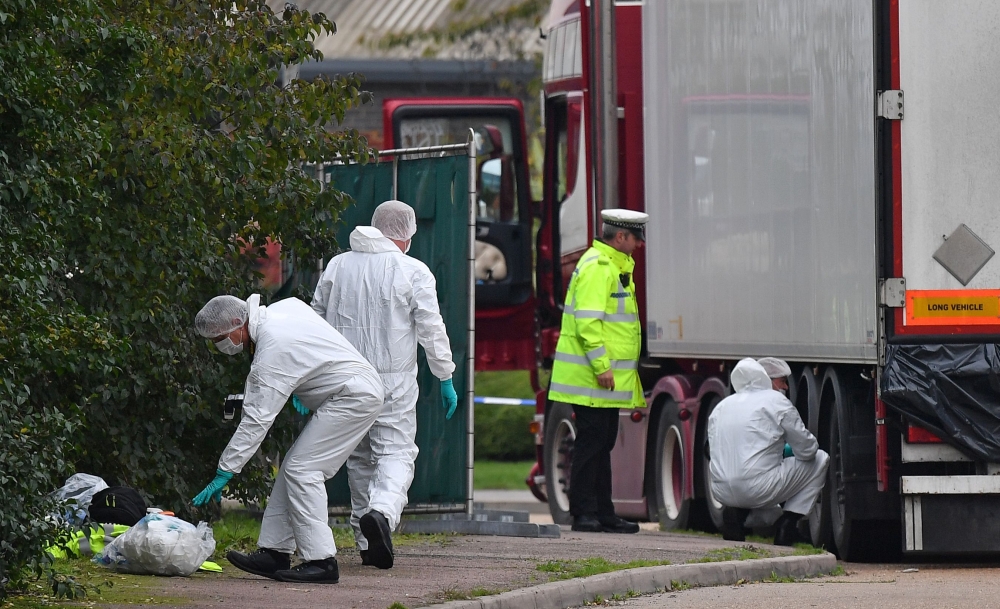 British Police forensics officers work on lorry, found to be containing 39 dead bodies, at Waterglade Industrial Park in Grays, east of London, on October 23, 2019. AFP / Ben Stansall