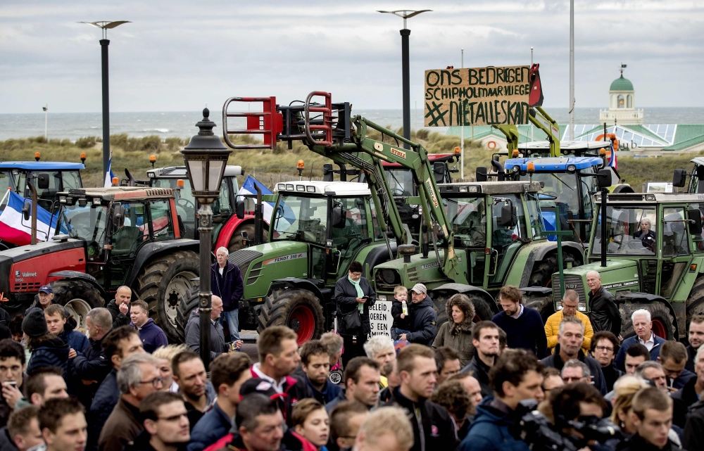 Dutch farmers gather beside their tractors at the Hotel van Oranje in Noordwijk on October 26, 2019, to demand that their views be heard on the popular Dutch television program 