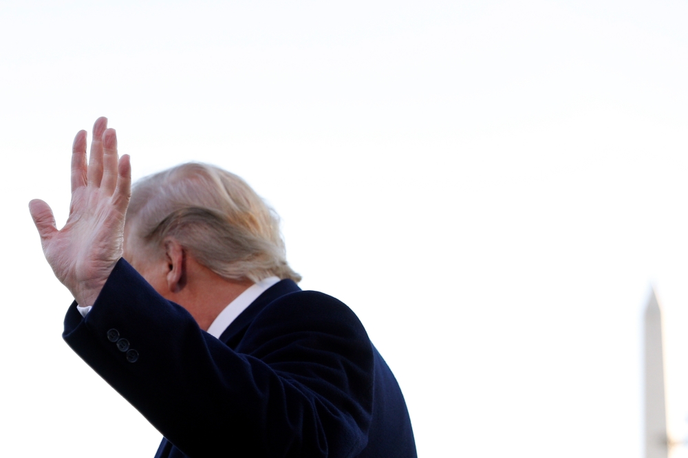 US President Donald Trump waves as he turns away from answering questions from reporters to depart for travel to Mississippi from the South Lawn of the White House, November 1, 2019. Reuters/Tom Brenner
 
