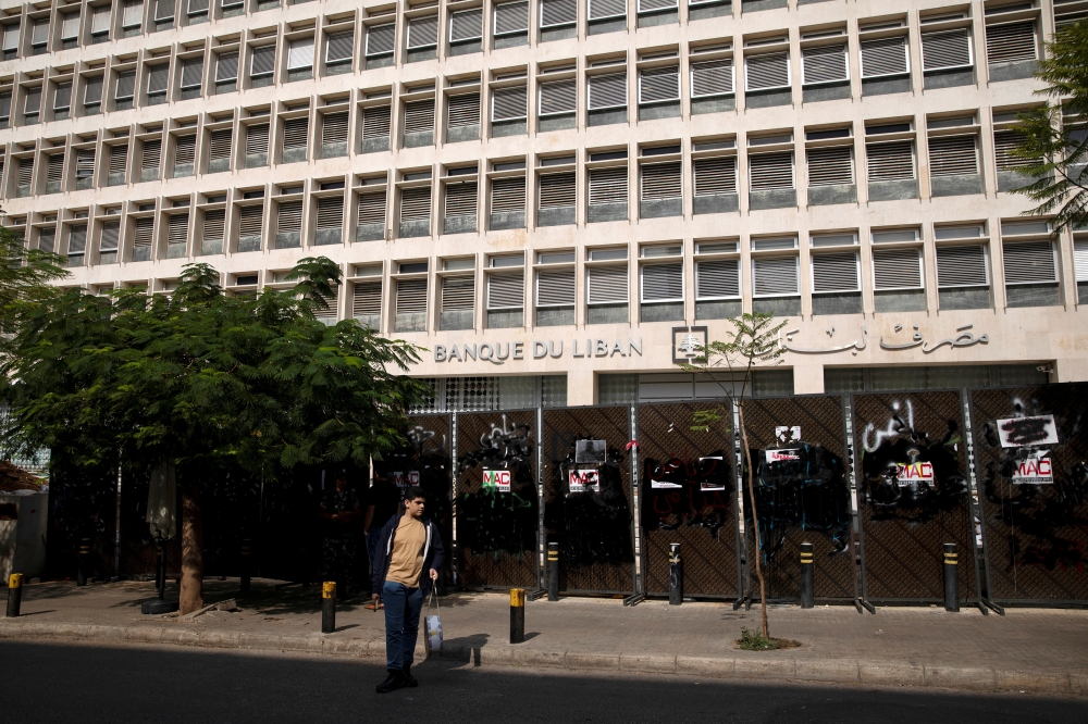 FILE PHOTO: A young demonstrator stands outside the Central Bank of Lebanon in Beirut, Lebanon, October 25, 2019. REUTERS/Alkis Konstantinidis/File Photo