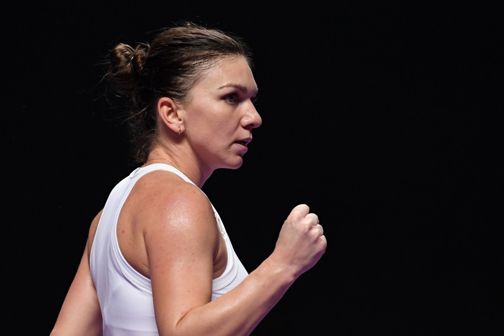 Simona Halep of Romania reacts during her women's singles match against Karolina Pliskova of Czech Republic in the WTA Finals tennis tournament in Shenzhen on November 1, 2019. / AFP / Noel CELIS