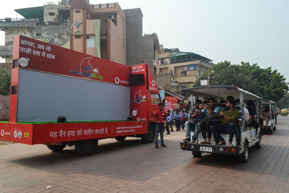 A vehicle equipped with an air purifier by Agra's Municipal Corporation and Agra Smart City in collaboration with a telecoms company is seen parked outside the Taj Mahal as tourists visit the site under heavy smog conditions in Agra on November 4, 2019. A