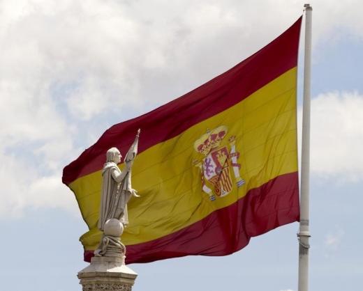 A statue of Christopher Columbus with an extended hand is seen in front of a Spanish flag in central Madrid, June 11, 2012. Reuters / Paul Hanna