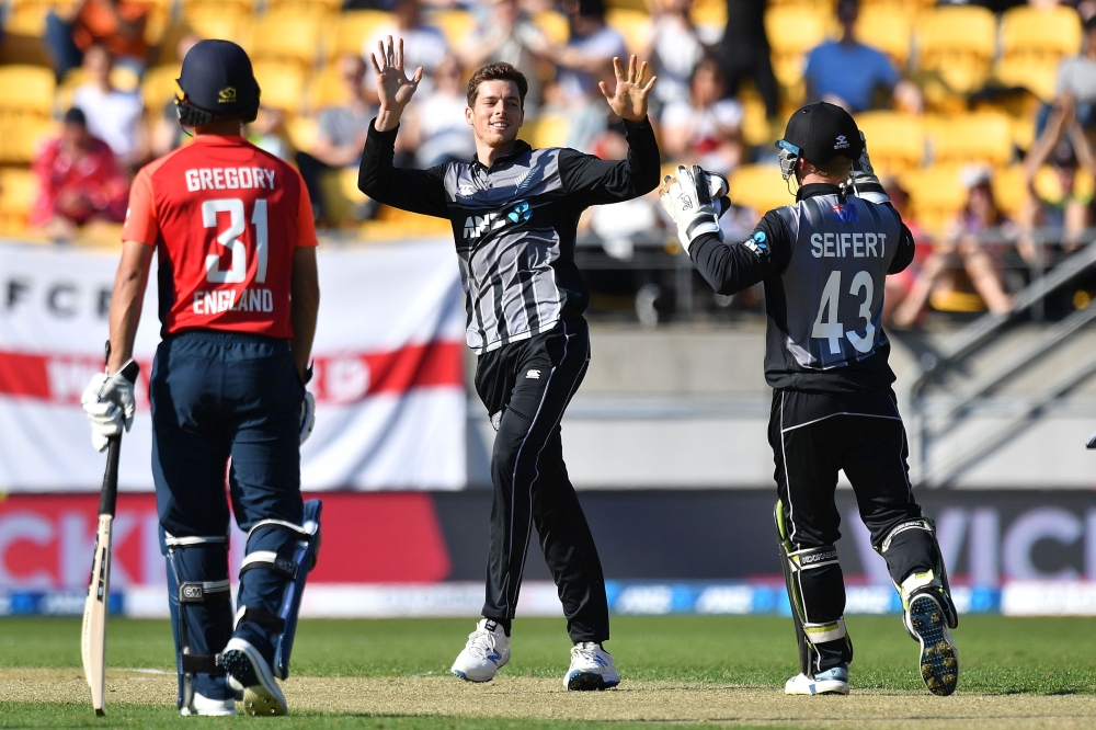New Zealand's Mitchell Santner (C) celebrates taking the wicket of England's Chris Jordan during the Twenty20 cricket match between New Zealand and England at Westpac Stadium in Wellington on November 3, 2019. AFP | Marty MELVILLE
