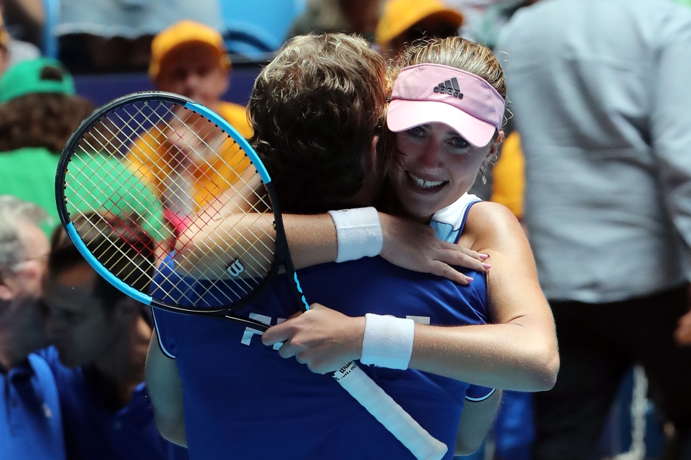 Kristina Mladenovic of France celebrates her victory against Ashleigh Barty of Australia with team's captain Julien Benneteau during the third rubber of the Fed Cup tennis final match between Australia and France in Perth on November 10, 2019. / AFP