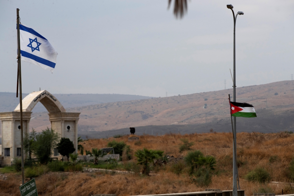 The national flags of Jordan and Israel are seen from the Israeli side of the border area between Israel and Jordan, in Naharayim October 29, 2019. Reuters/Ronen Zvulun
 