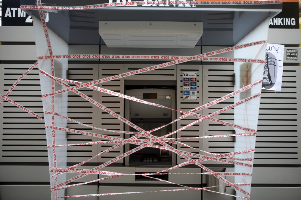 A picture taken on on November 11, 2019, shows an ATM which has been sealed by Lebanese anti-government protesters in the capital Beirut during a rally against the banking system. AFP / Patrick Baz