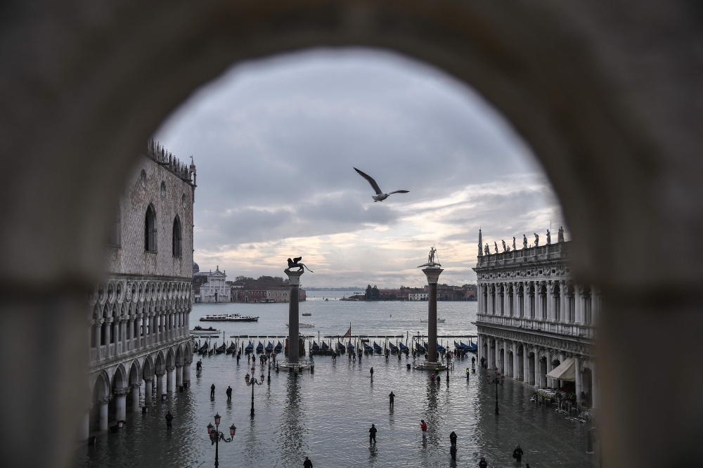 A general view shows the Doge's Palace (L) overlooking the flooded St. Mark's Square, the Lion of St. Mark winged bronze statue (Rear L), gondolas and the Venetian lagoon in the distance after an exceptional overnight 