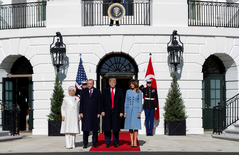 U.S. President Donald Trump and first lady Melania Trump stand with Turkey's Pressident Tayyip Erdogan and Emine Erdogan upon their arrival at the White House in Washington, U.S., November 13, 2019. (REUTERS/Tom Brenner)