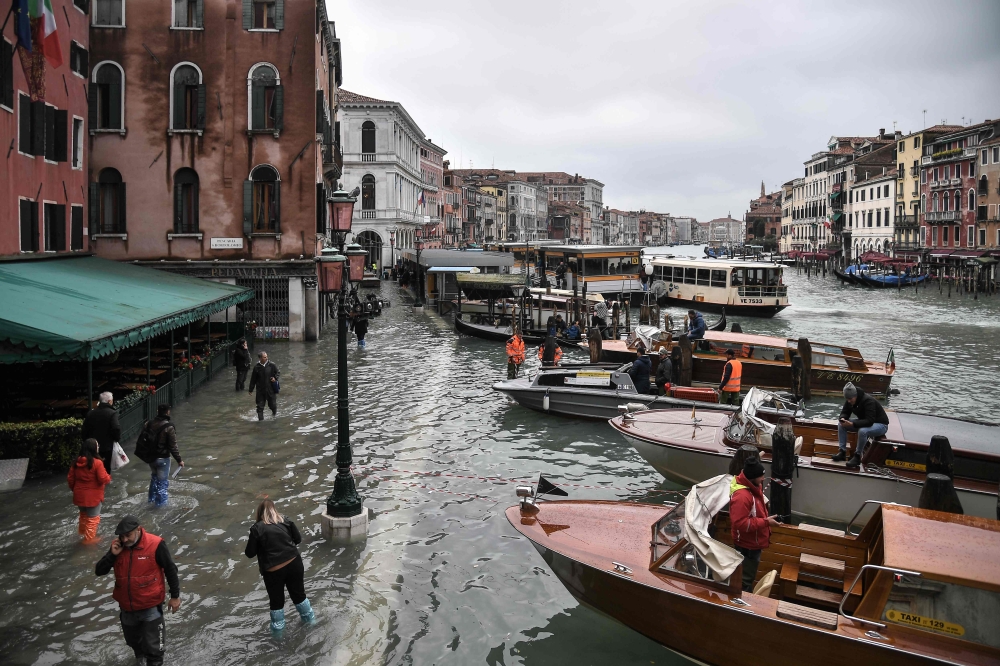 A general view shows the flooded embankment by the Hotel Rialto (L) and taxi boats on the Grand Canal channel, as seen from the Rialto bridge, after an exceptional overnight 