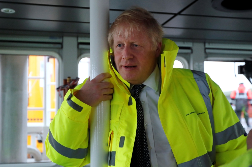 Britain's Prime Minister Boris Johnson leans on a pole in the steering cabin of a tugboat during a general election campaign stop in the port of Bristol, Britain November 14, 2019. Frank Augstein/Pool via REUTERS