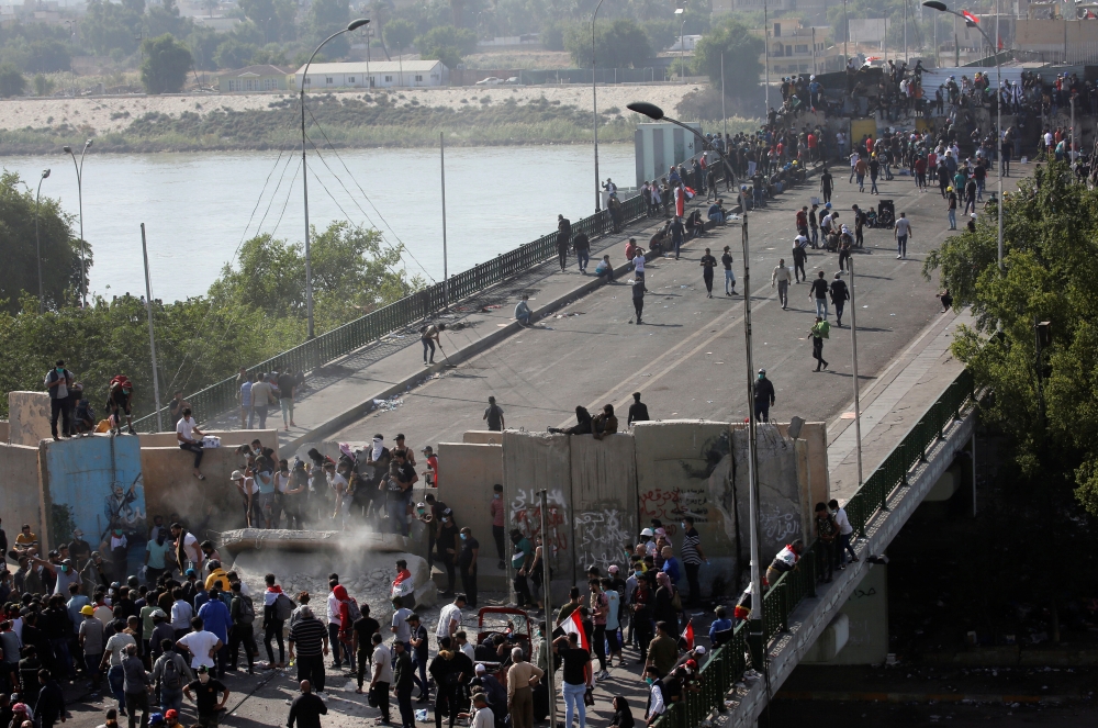 Iraqi demonstrators smash concrete walls at Sinak Bridge during the ongoing anti-government protests, in Baghdad, Iraq November 16, 2019. REUTERS/Wissm al-Okili