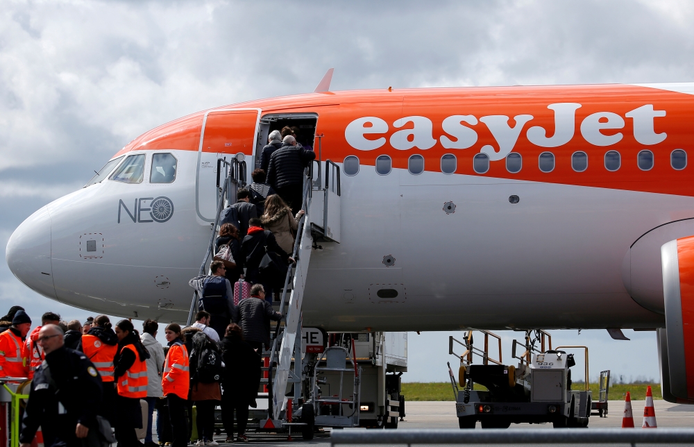 FILE PHOTO: Passengers board an easyJet plane at the Nantes-Atlantique airport in Bouguenais near Nantes, France, April 4, 2019. REUTERS/Stephane Mahe/File Photo