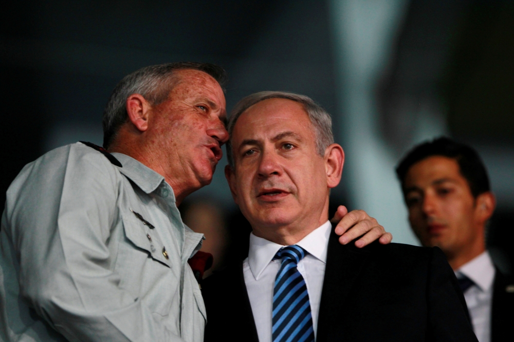 FILE PHOTO: Benjamin Netanyahu and Benny Gantz speak during the opening ceremony of the 19th Maccabiah Games at Teddy Stadium in Jerusalem, July 18, 2013. Reuters / Baz Ratner