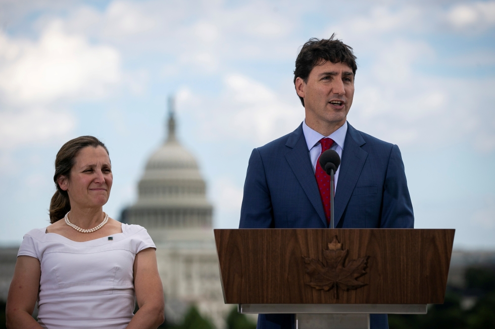 Canada's Prime Minister Justin Trudeau speaks as Canada's Foreign Minister Chrystia Freeland listens during a news conference at the Canadian Embassy, in Washington, US June 20, 2019. Reuters/Al Drago