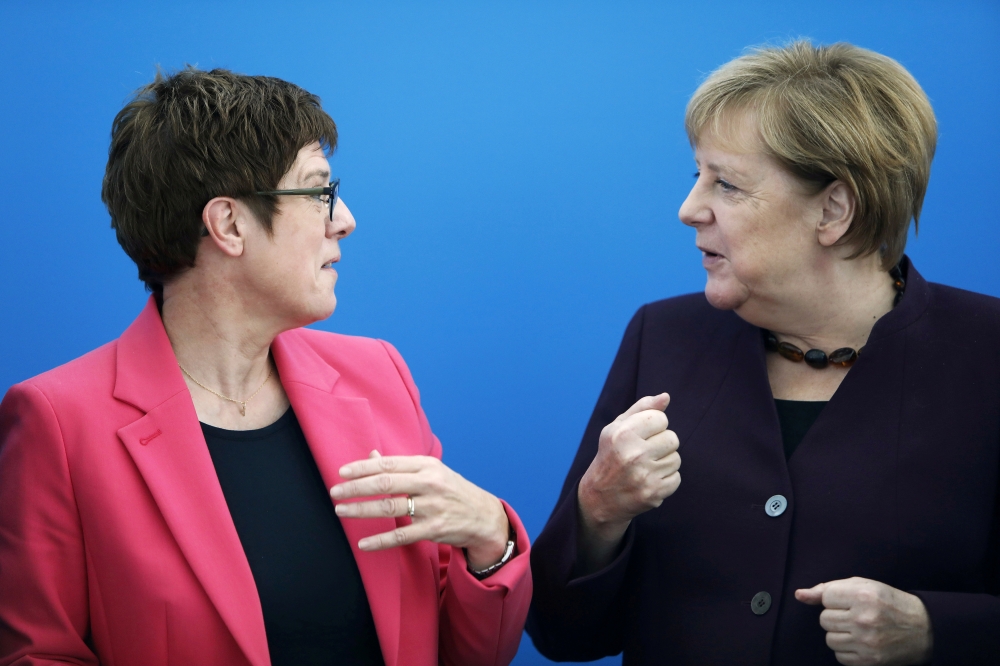 FILE PHOTO: Germany's Defence Minister and CDU Chairwoman Annegret Kramp-Karrenbauer and Chancellor Angela Merkel attend a CDU board meeting in Berlin, Germany, October 14, 2019. REUTERS/Michele Tantussi/File Photo