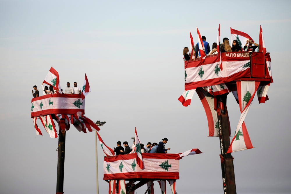 People attend a parade, on the 76th anniversary of Lebanon's independence, from a crane platform at Martyrs' Square in Beirut, Lebanon November 22, 2019. Reuters/Andres Martinez Casares