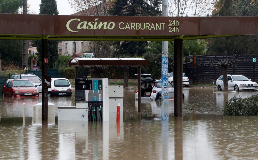 Partially submerged cars are seen in a flooded gas station after heavy rainfall in Le Muy, France, November 24, 2019. REUTERS/Eric Gaillard