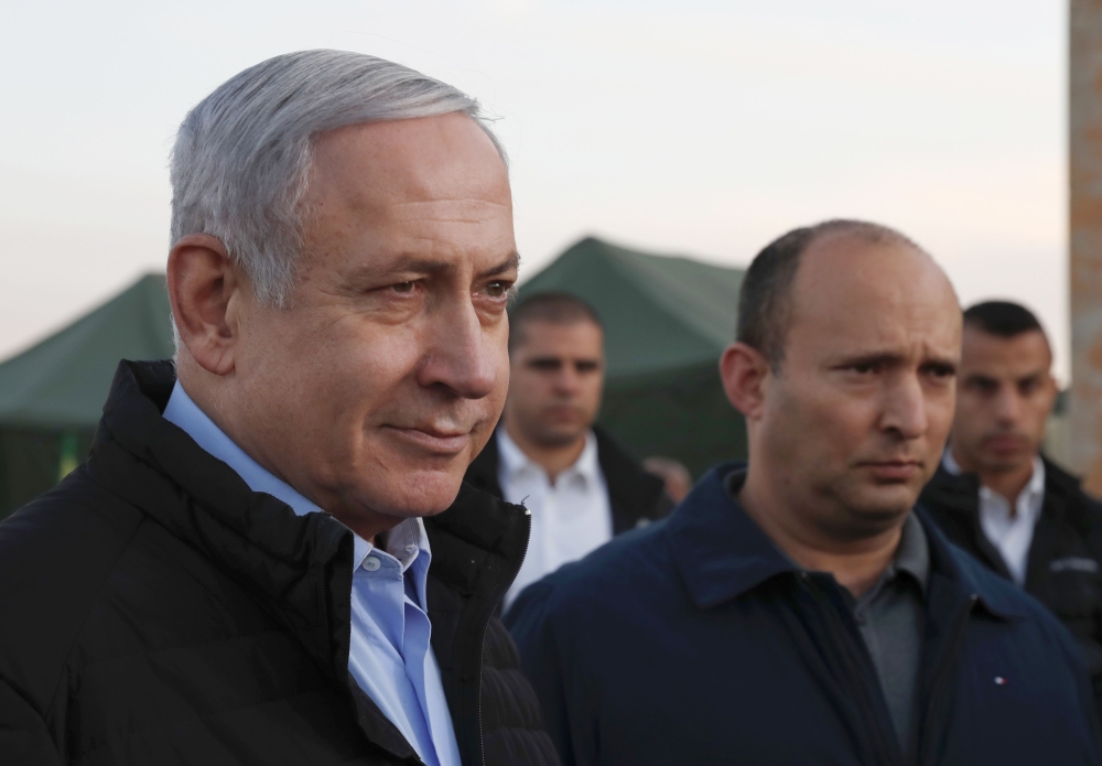 Israel's Prime Minister Benjamin Netanyahu (L) and Defence Minister Naftali Bennett (2nd) visit an army base in the Israeli-annexed Golan Heights overlooking Syrian territory, on November 24, 2019. AFP / Atef Safadi
 