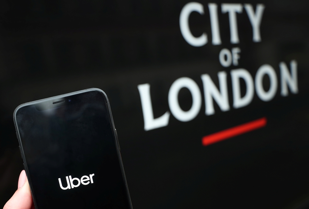 The uber logo is displayed on a mobile phone in this picture illustration taken November 25, 2019. REUTERS/Hannah McKay/Illustration

