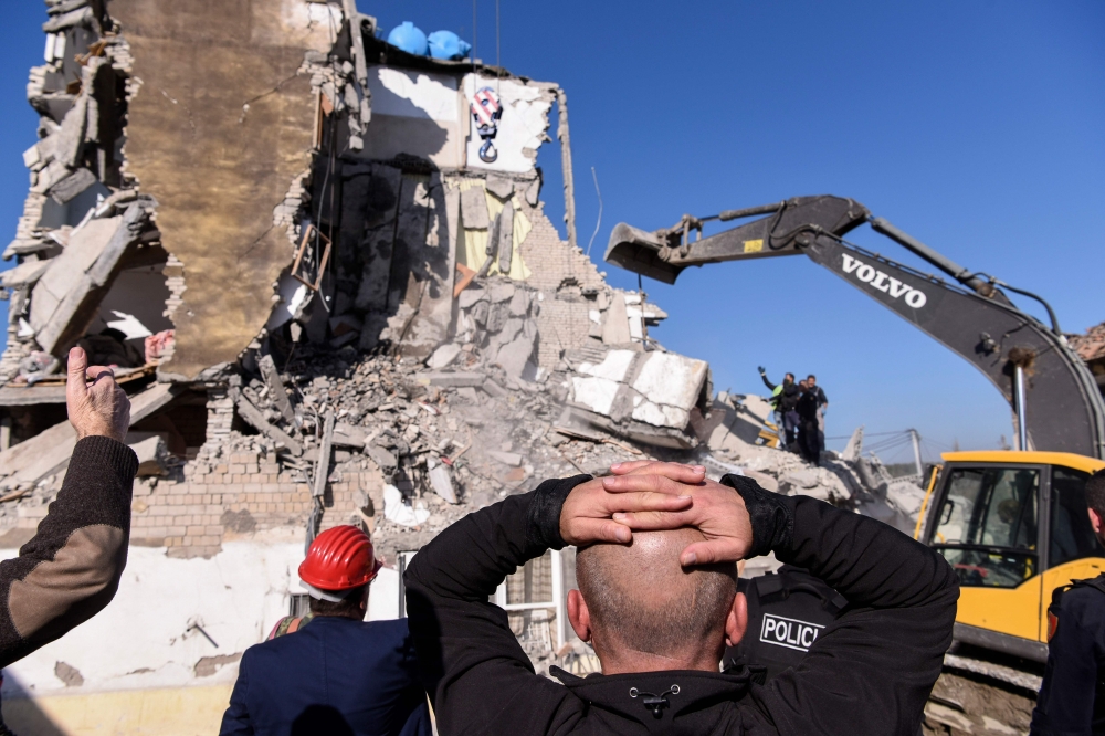 Rescue workers remove debris from a collapsed building in Thumane, northwest of capital Tirana, after an earthquake hit Albania, on November 26, 2019.  AFP / Armend NIMANI