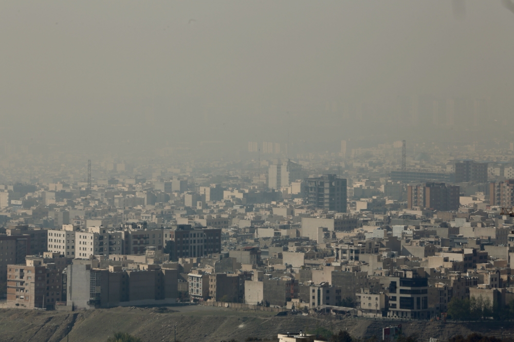 In this file photo taken on November 13, 2019 A general view taken from Western Tehran shows a blanket of brown-white smog covering the city as heavy pollution hit the Iranian capital on November 13, 2019. / AFP / ATTA KENARE 