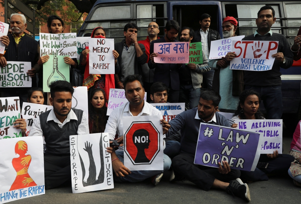 People hold placards and shout slogans as they take part in a protest against the alleged rape and murder of a 27-year-old woman on the outskirts of Hyderabad, in New Delhi, India, November 30, 2019. REUTERS/Anushree Fadnavis