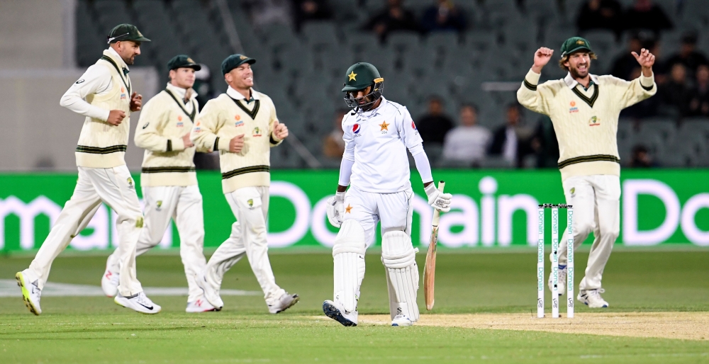 Pakistan batsman Asad Shafiq (C) walks off after been dismissed by Australia on the second day of the second cricket Test match in Adelaide on November 30, 2019. / AFP / William WEST /