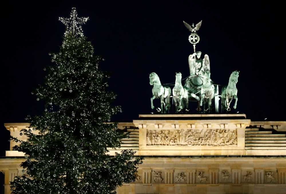 An illuminated Christmas tree is pictured in front of the Brandenburg Gate in Berlin, Germany, December 1, 2019. Reuters/Fabrizio Bensch
 