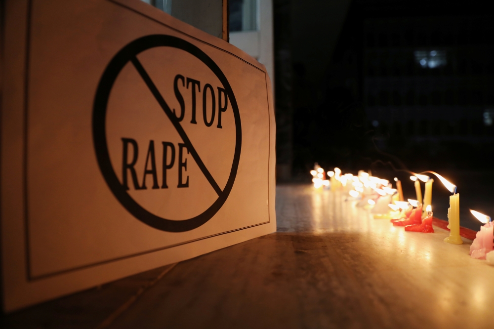 A poster is seen at a candle-lit march by the resident doctors and medical students from All India Institute Of Medical Sciences (AIIMS) to protest against the alleged rape and murder of a 27-year-old woman on the outskirts of Hyderabad, in New Delhi, Ind
