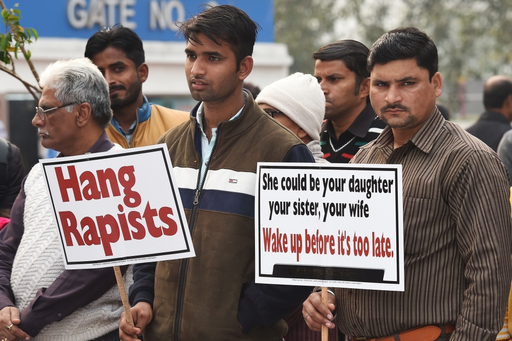 Demonstrators hold placards to protest against the alleged rape and murder of a 27-year-old veterinary doctor in Hyderabad, during a demonstration in New Delhi on December 6, 2019. AFP / Prakash Singh 