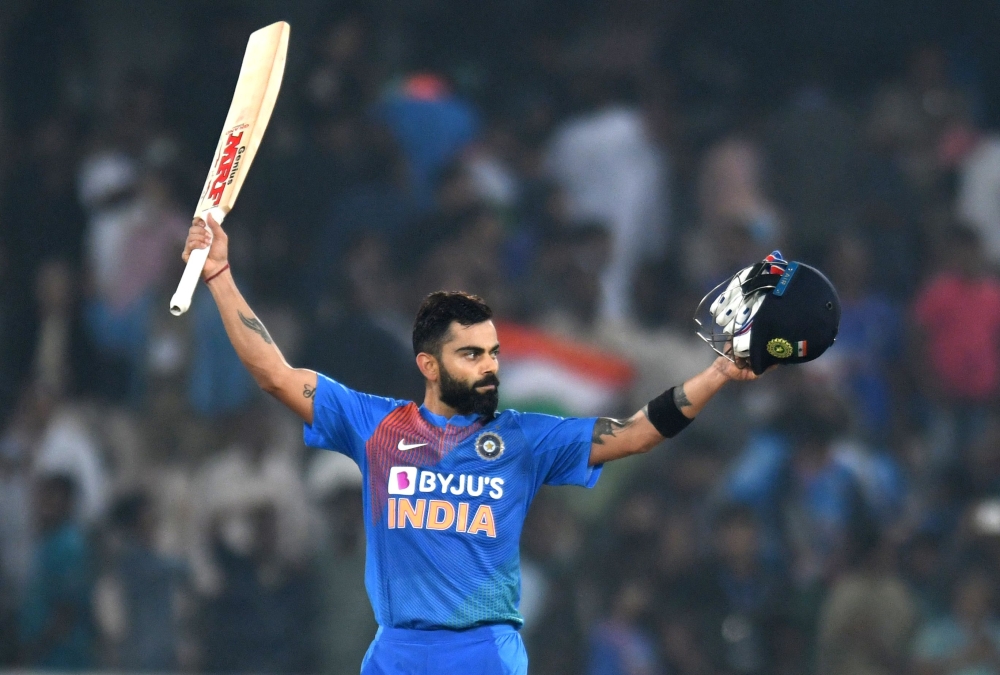 Indian cricket captain virat kohli raise his bat after winning the match against West Indies during the first T20 international cricket match of a three-match series between India and West Indies at the Rajiv Gandhi International Cricket Stadium in Hydera