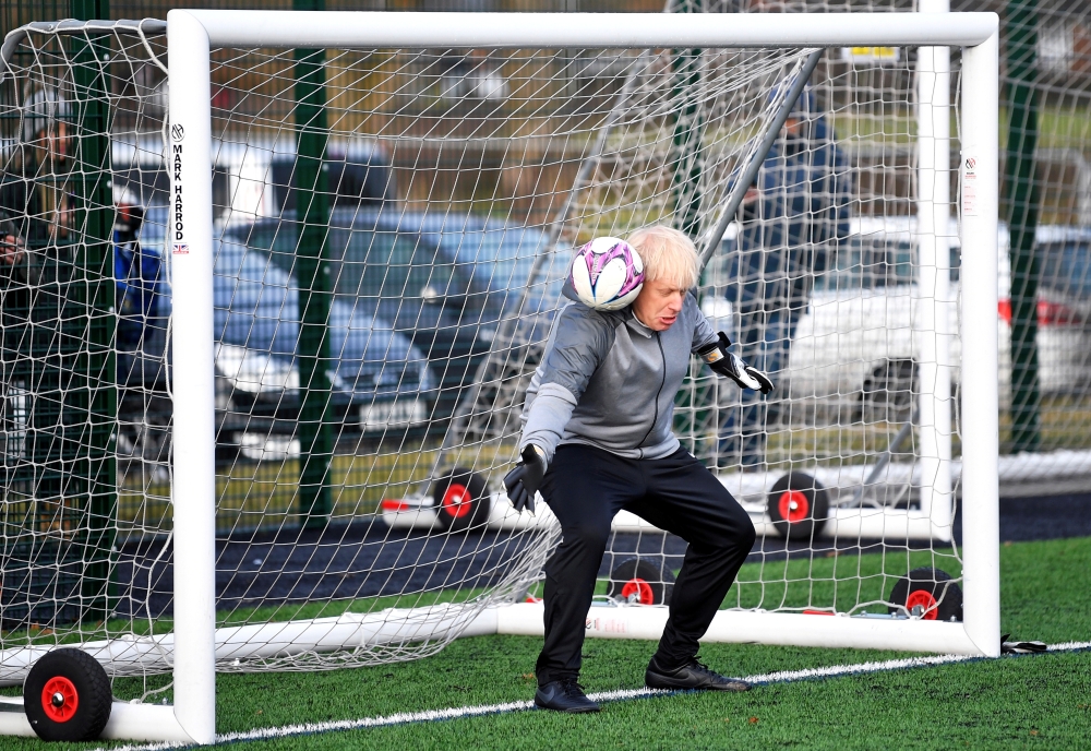 Britain's Prime Minister Boris Johnson attends a warm-up before the Hazel Grove United JFC vs Poynton Juniors girls soccer match, as he campaigns in Cheadle Hulme, Britain December 7, 2019. Reuters/Toby Melville/Pool