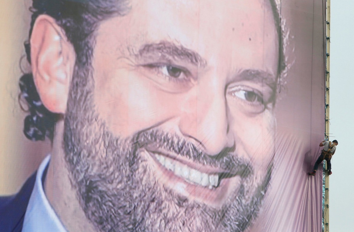 A worker is seen fixing a huge banner depicting Saad al-Hariri in the southern city of Sidon, Lebanon, November 18, 2017. Reuters / Ali Hashisho