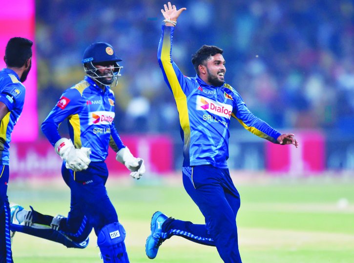 File photo of Sri Lanka's spinner Wanindu Hasaranga (R) celebrates with teammates after dismissal of Pakistan's captain Sarfraz Ahmed during the second Twenty20 International cricket match between Pakistan and Sri Lanka at the Gaddafi Cricket Stadium in L