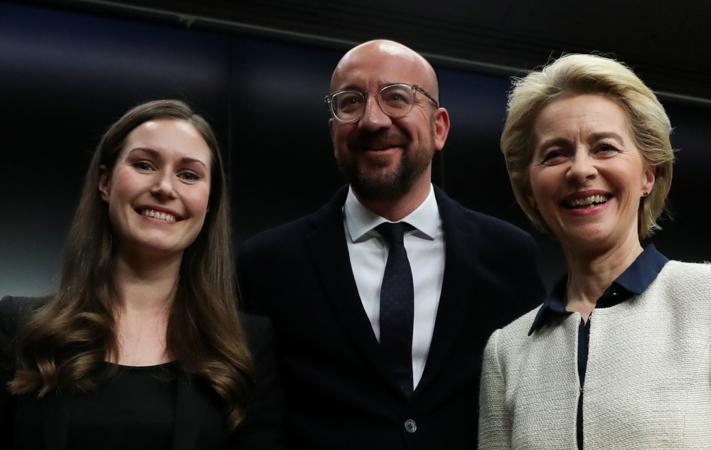 Finland's Prime Minister Sanna Marin, European Council President Charles Michel and European Commission President Ursula von der Leyen pose after a joint news conference at the end of the European Union leaders summit in Brussels, Belgium December 13, 201