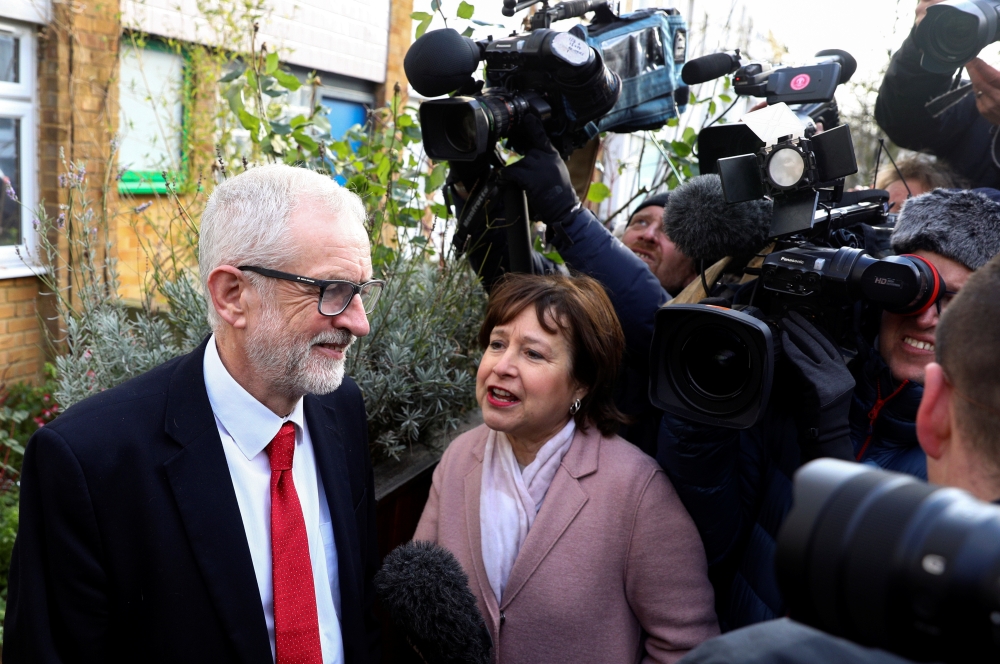 Labour Party leader Jeremy Corbyn talks to the media as he leaves his home, following the results of the general election, in London, Britain, December 13, 2019. Reuters/Tom Nicholson
 