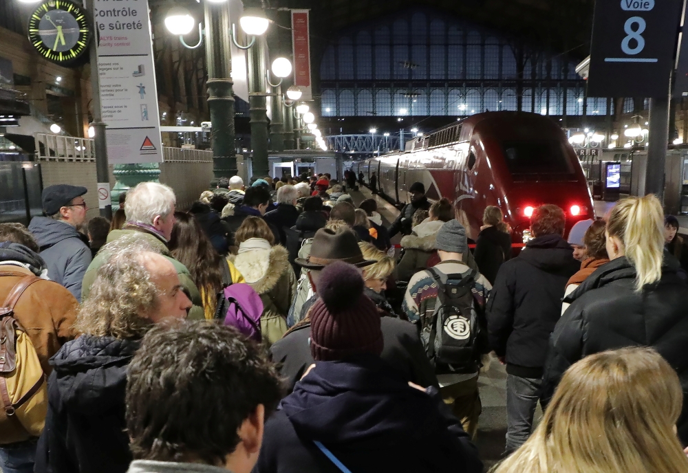 Commuters wait to take a train at Gare du Nord train station during a strike by all unions of French SNCF workers and the Paris transport network (RATP), as France faces its tenth consecutive day of strikes against French government's pensions reform plan