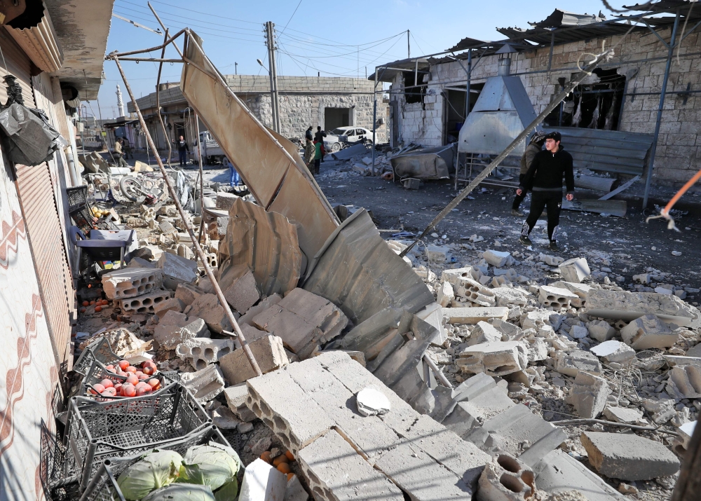 Syrians check the site of a reported government bombardment in the village of Maasaran on the outskirts of Maaret al-Numan in northwestern Idlib province on December 17, 2019. AFP / Omar Haj Kadour 