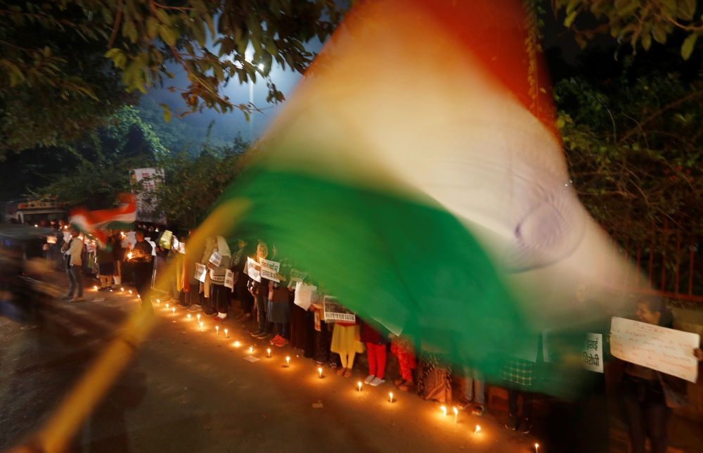 Local residents take part in a candle light vigil to show solidarity with the students of the Jamia Millia Islamia university after police entered the university campus on Sunday following a protest against a new citizenship law, in New Delhi, India Decem