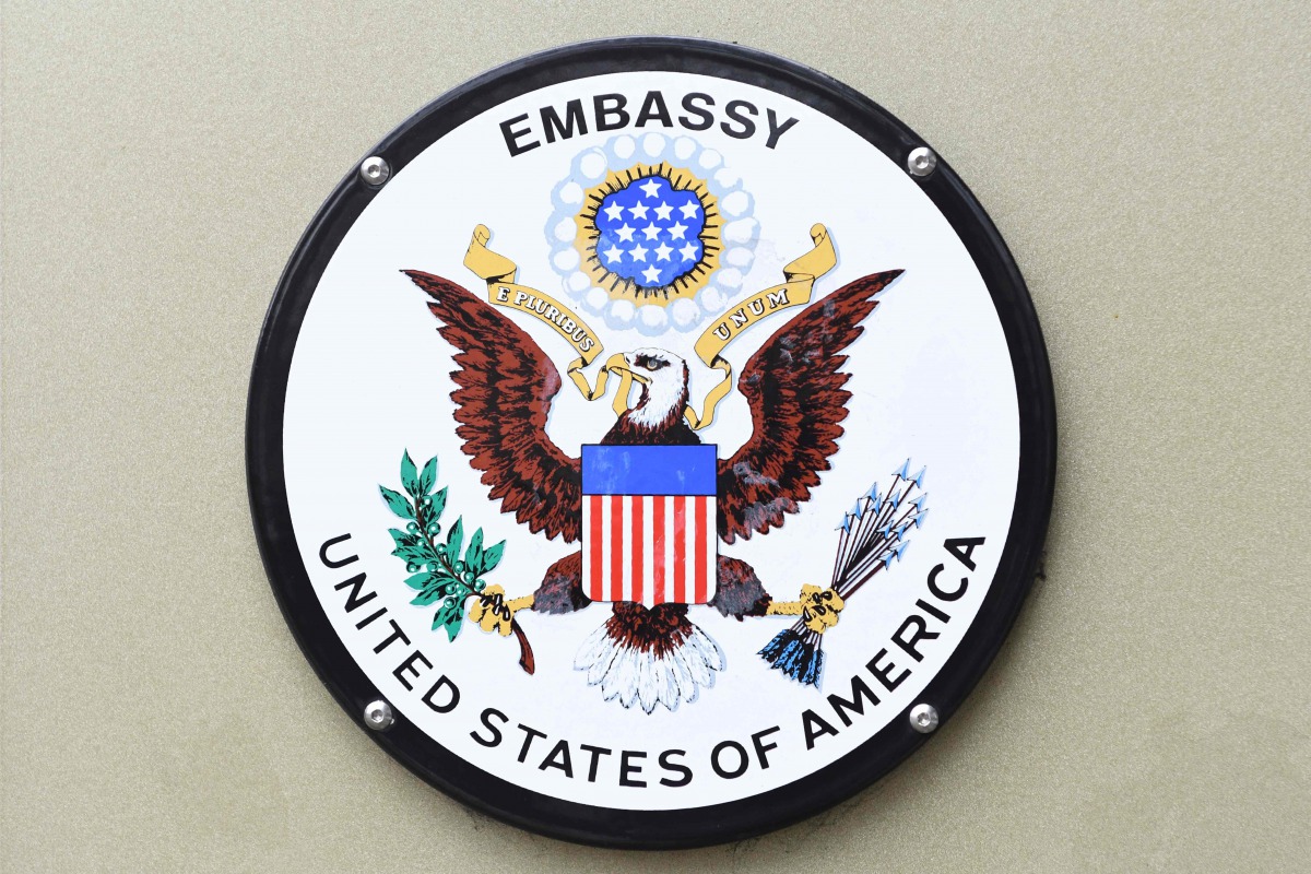 Signs attached to the railings of the US embassy in Grosvenor square in central London on January 12, 2018. AFP  / Daniel Sorabji