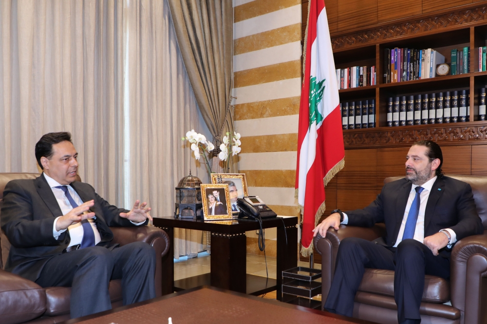 Lebanese outgoing prime minister Saad Hariri meets with Prime Minister-designate Hassan Diab (L) in Beirut on December 20, 2019. AFP