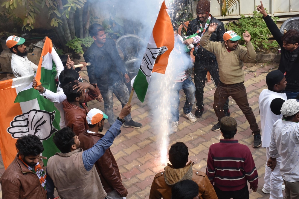 Congress-JMM alliance workers celebrate results projecting an assembly majority in the Jharkhand state election in Ranchi on December 23, 2019.  AFP / Rajesh Kumar
 